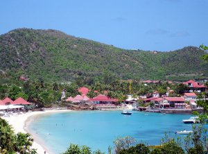 Beach goers frolick in the water of St. Barth's
