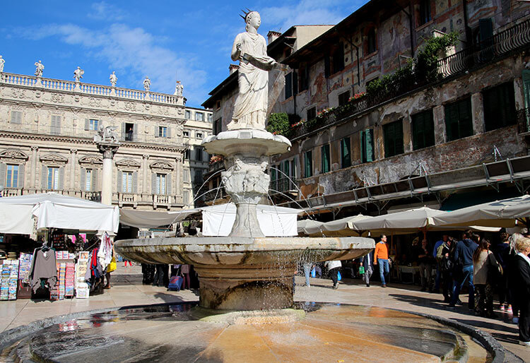 Market stalls fill every inch of Piazza delle Erbe and a 14th century fountain stands in the middle of the square