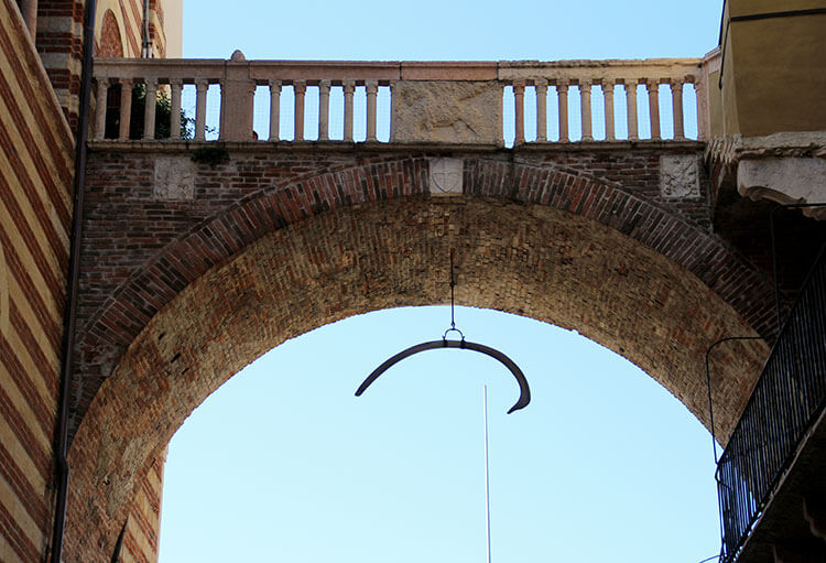 A whale bone is hung from the under part of the Arco della Costa in Verona