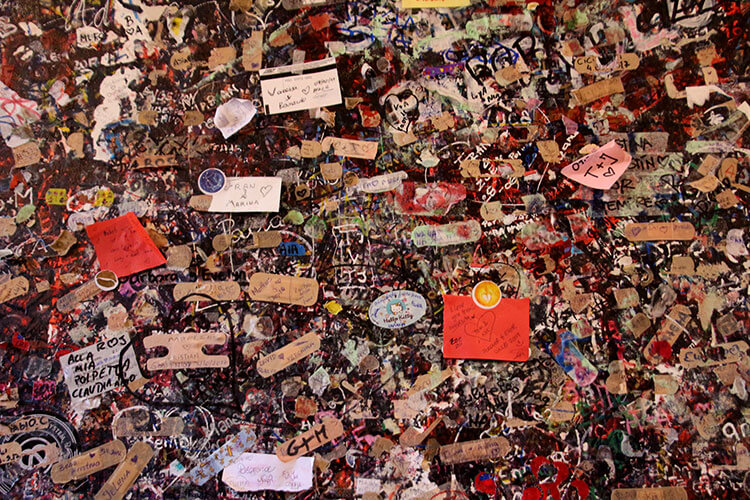 Every inch of a wall is covered in hundreds of thousands of love notes at Juliet's house in Verona