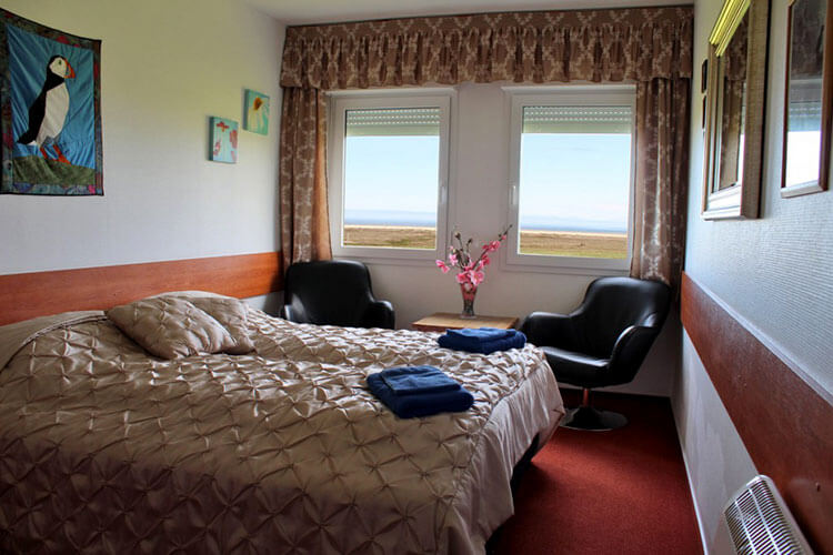 A double room with private bathroom at Breidavik Guest House has a sea view