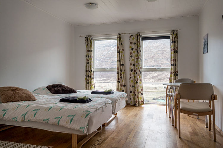 A double room at Heydalur with hard wood floors and a view of the mountains
