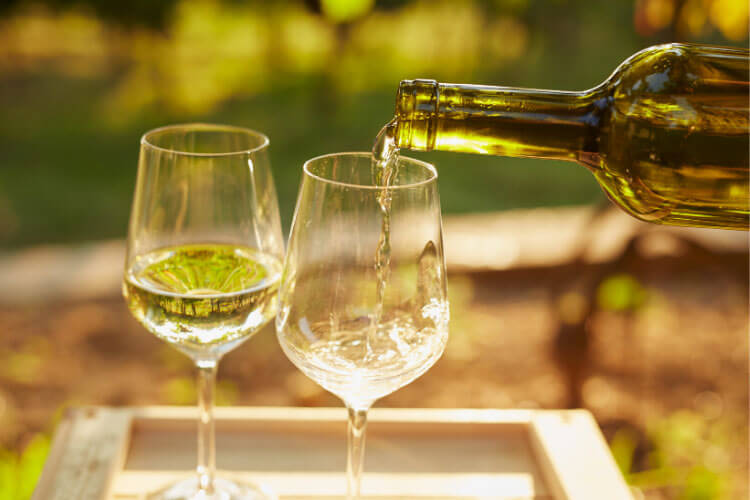 Pouring two glasses of Vernaccia di San Gimignano