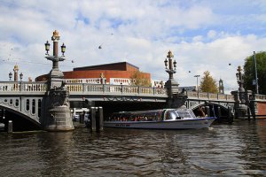 A cruise boat passes beneath Amsterdam's Blue Bridge