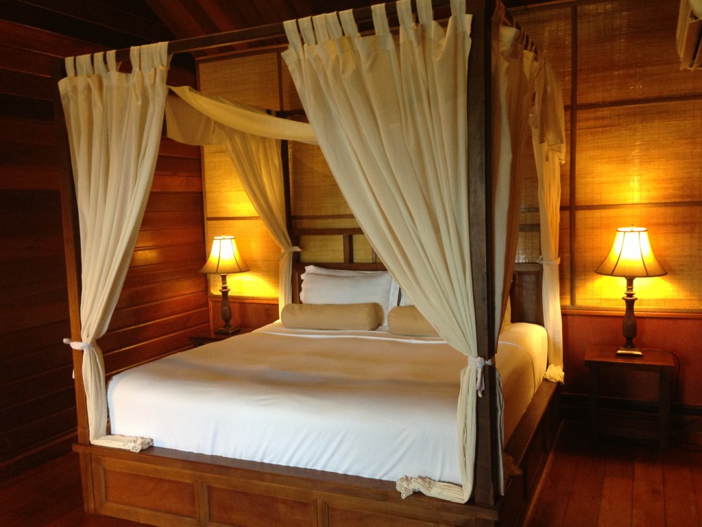 Four-poster bed in hillside cabin on Manukan Island