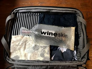 Jennifer uses a WineSkin to seal a bottle of wine in her suitcase