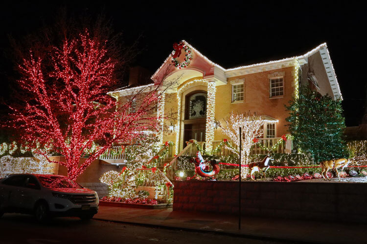 A house in the Bay Ridge neighborhood is done up in red and white lights with a life-size Santa in a sleigh pulled by reindeer in Brooklyn, New York