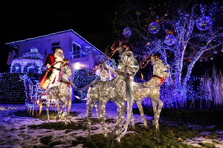 A life-size Santa on a sleigh with reindeer on the lawn of a Dyker Heights home in Brooklyn, New York