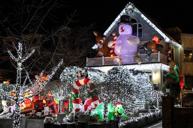 Inflatable candy canes, a giant Frosty, Rudolph, elves and other characters decorate the lawn and balcony of a house in Dyker Heights, Brooklyn