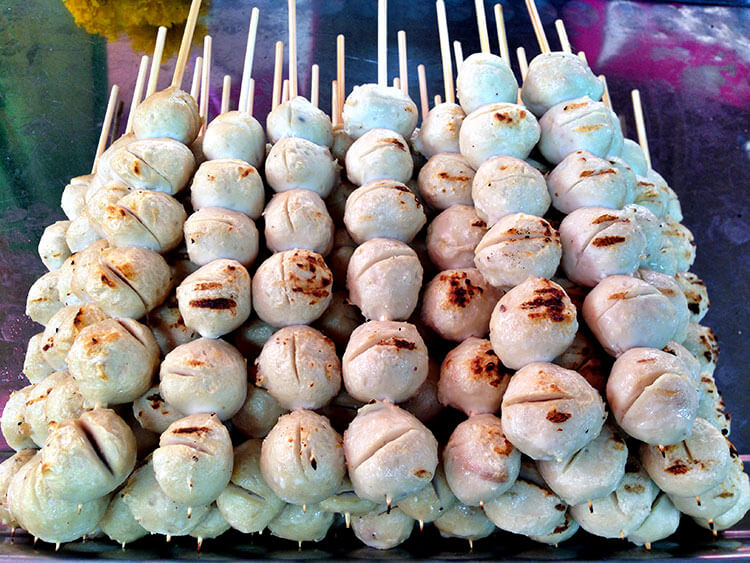 A platter of Thai pork meatballs on sticks stacked up at the Taling Chan Floating Market