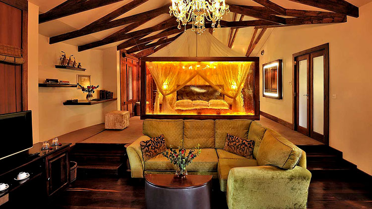 Our plantian suite with green and gold interiors and dark wood at Arusha Coffee Lodge