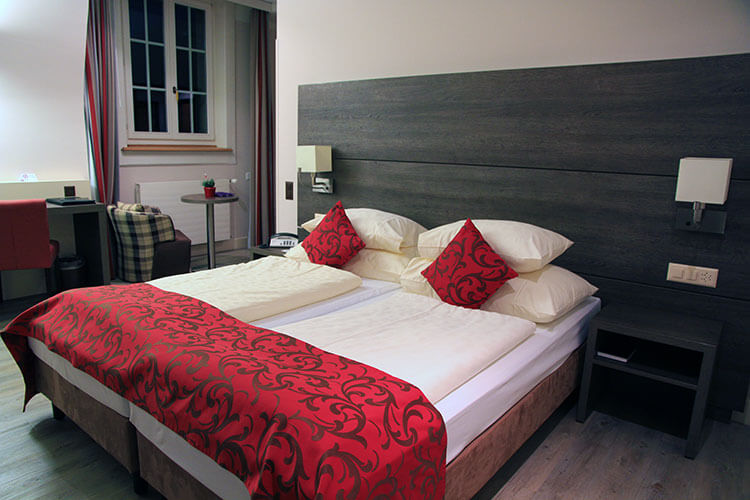 Simple, yet chic design at Hotel Solsana with wood accents and red fabric