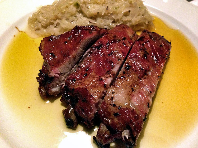 Three pork ribs with a side of sauerkraut at Maso Runch