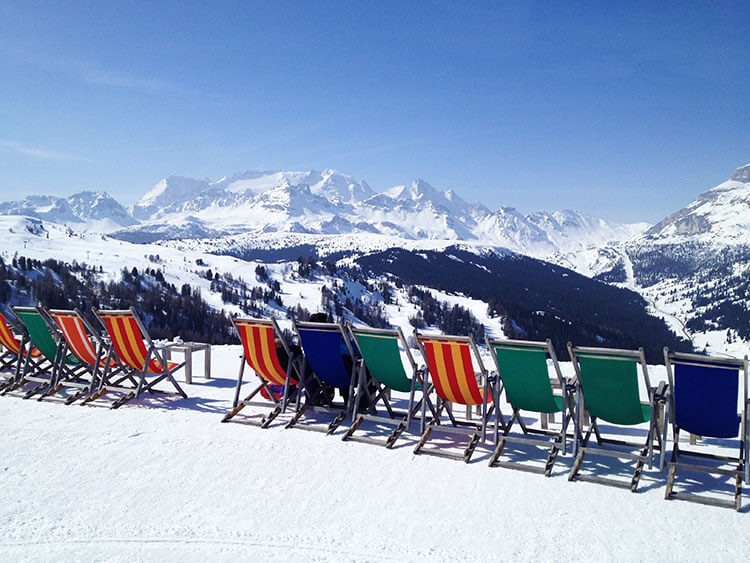 Colorful lounge chairs are positioned for enjoying the mountain views