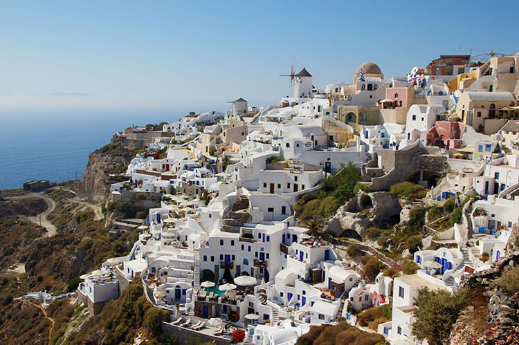 A viewpoint over the white washed buildings and windmill of Oia, Santorini
