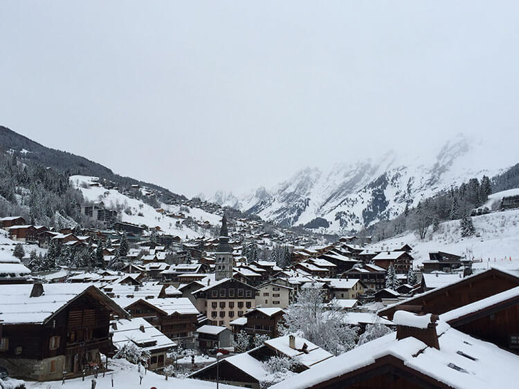 A snowy view of the village of La Clusaz from our balcony at Hotel Les Sapins