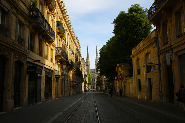 The spires of Cathedral Saint-Andre seen from looking down Rue Vital Carles