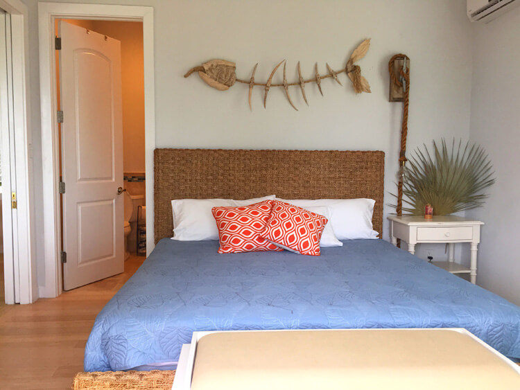 One of two master bedrooms decorated in shabby chic decor at the Sandy Toes cottage on Rose Island, Bahamas