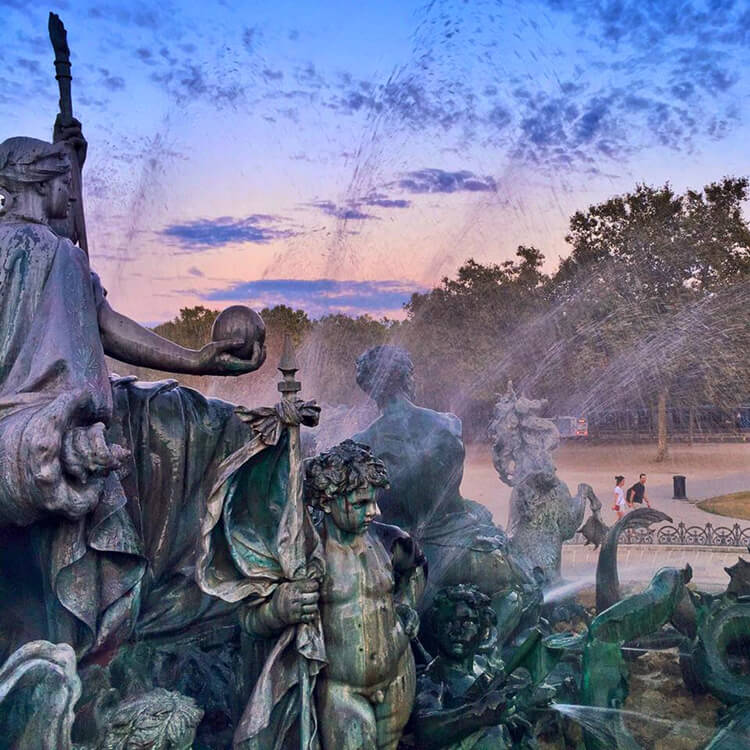 Close up of the Monument aux Girondins with the water fountain spraying up at sunset 