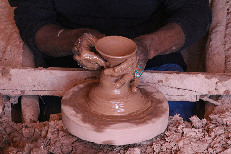 A potter makes pottery in Tamegroute, Morocco