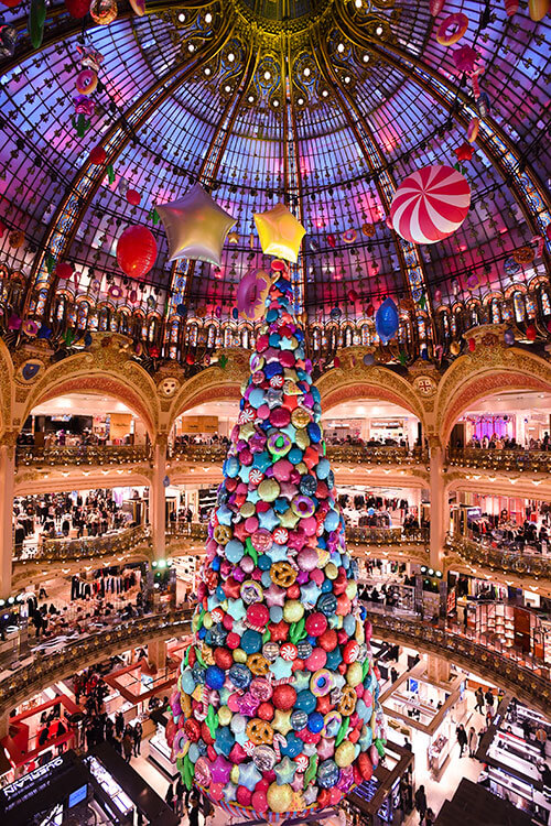 The Christmas tree in Galeries Lafayette decorated with candy decorations under the glass dome in Paris, France