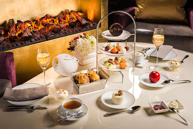 The afternoon tea service by a roaring fire in the Camelia restaurant at the Mandarin Oriental Paris