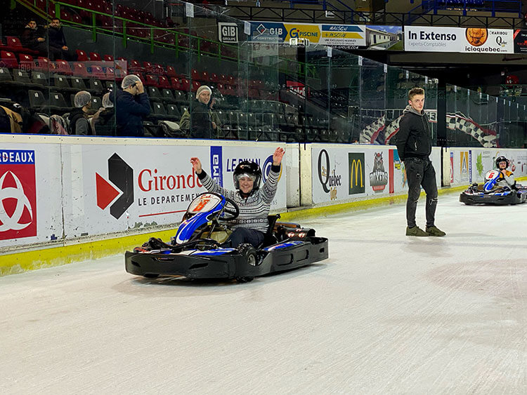 Jennifer sitting in her ice kart at the finish of the race cheering 