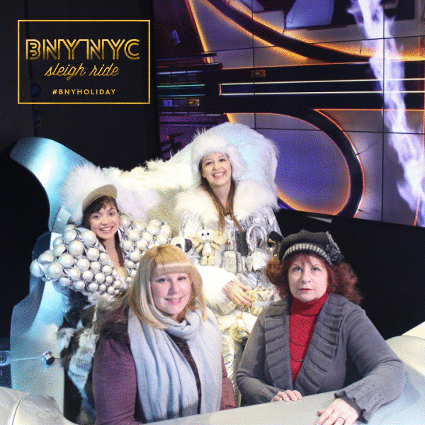 An animated set of four photos of Jennifer and her mom in the sleigh ride photo booth at Barney's