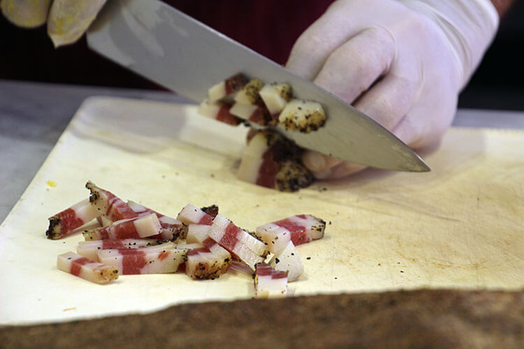 Chopping up pancetta 