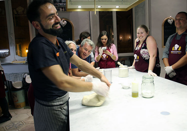 Our instructor showing us how to roll out the pizza dough