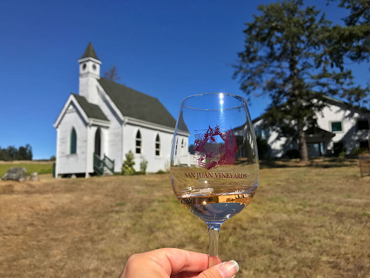 A glass of rose wine and the church at San Juan Vineyards