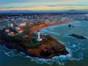 Drone photo of the Biarritz Lighthouse and sunset colors along the Grand Plage