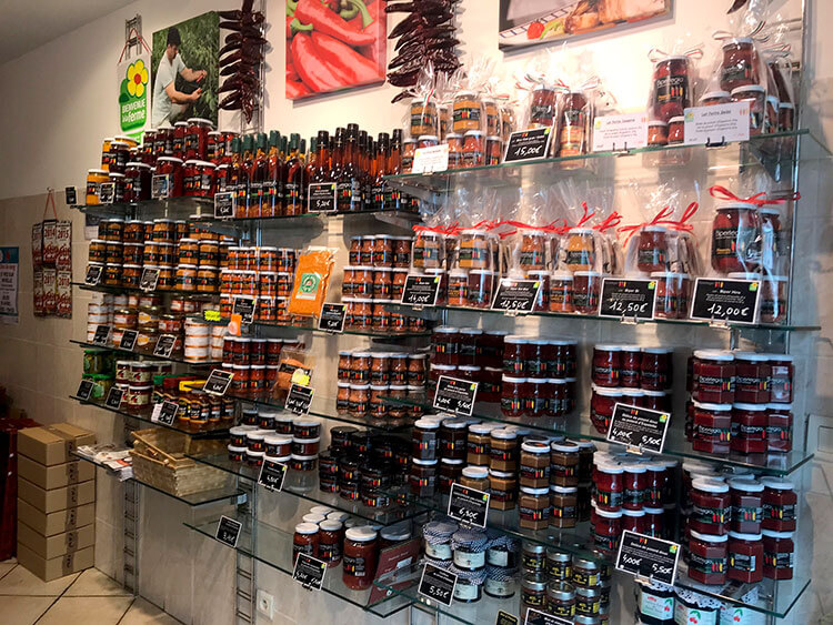 A wall of various pepper products in a shop in Espelette
