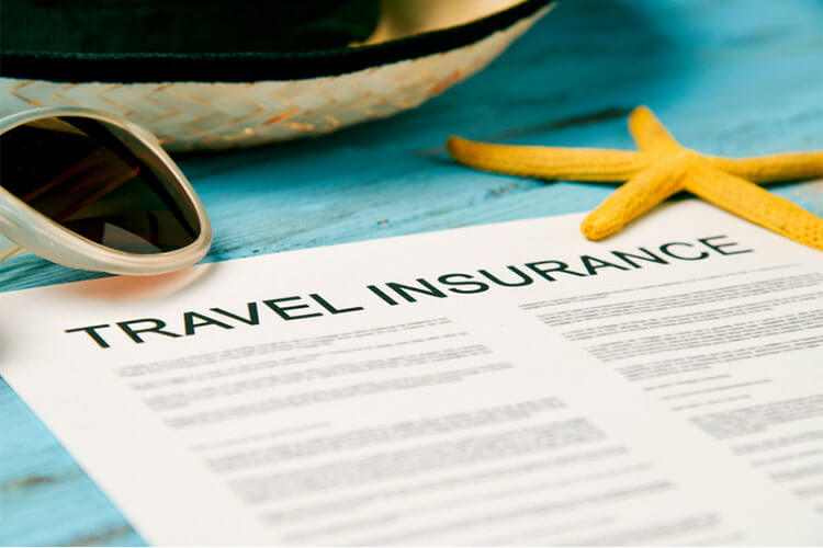 Travel insurance policy, sun hat and sunglasses 