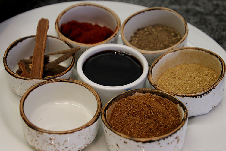 Cinnamon and various spices in little bowls used in Arabic cooking