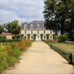 A long paved walkway leads to the main chateau and is lined with beds of marigolds