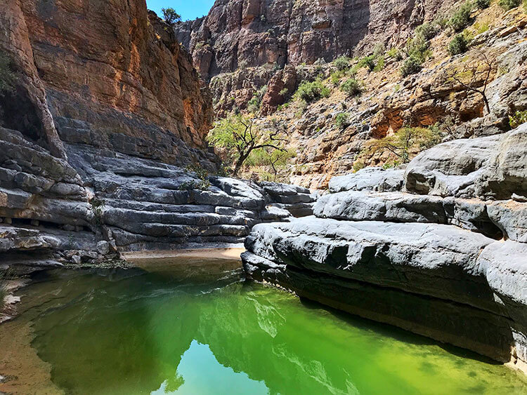 Green water of Wadi al Bawaarid deep inside the canyon in Jebel Akhdar