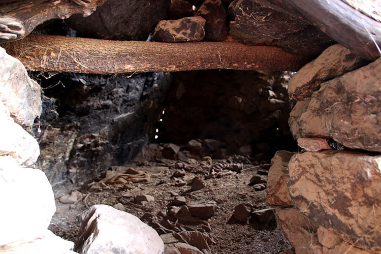A small room made from rocks and wood to shelter the rebel