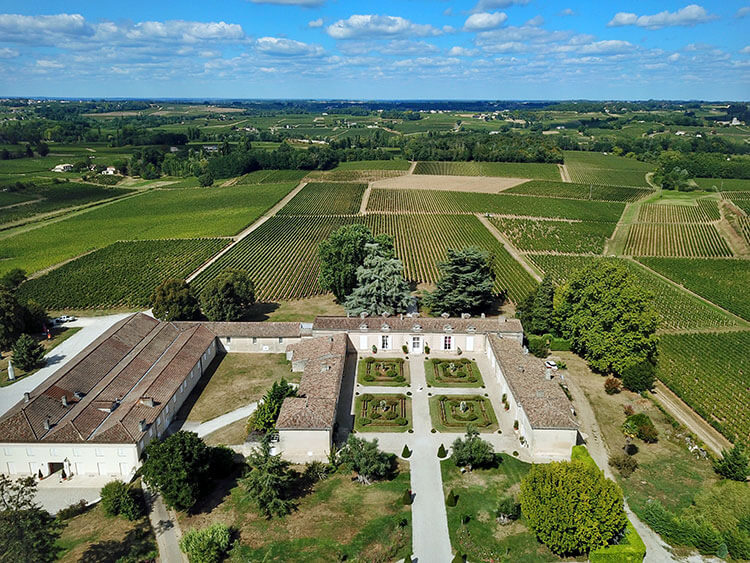 Drone aerial of Chateau Fombrauge surrounded by vinyeards