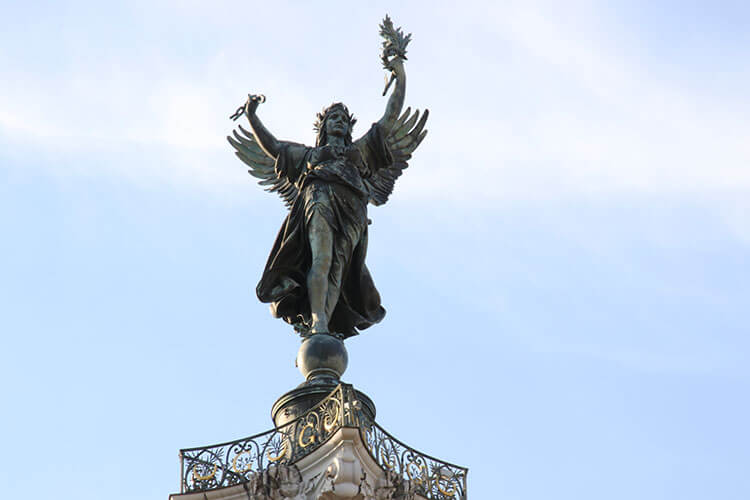 A close-up of the Statue of Liberty that tops the Monument aux Girondins with broken chains in her hands