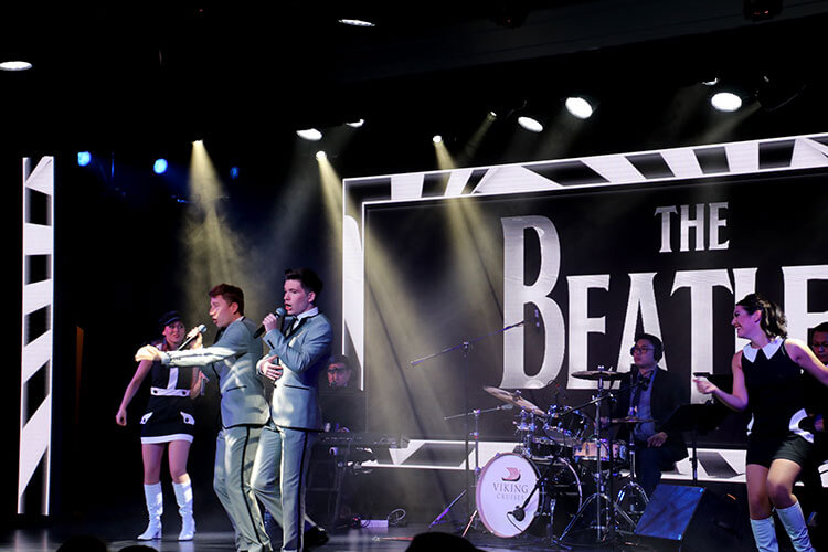 The Viking singers performing in black and white outfits during a Beatles show in the Star Theater