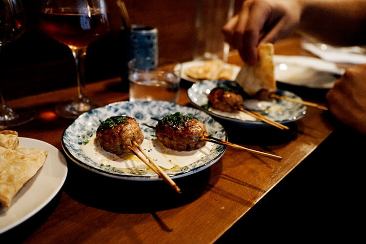 Le Rigmarole's take on meatballs, served on a stick with a side of buttery flatbread