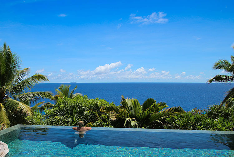 Jennfer looking out to the ocean in the infinity pool at Fregate Island Private in Seychelles