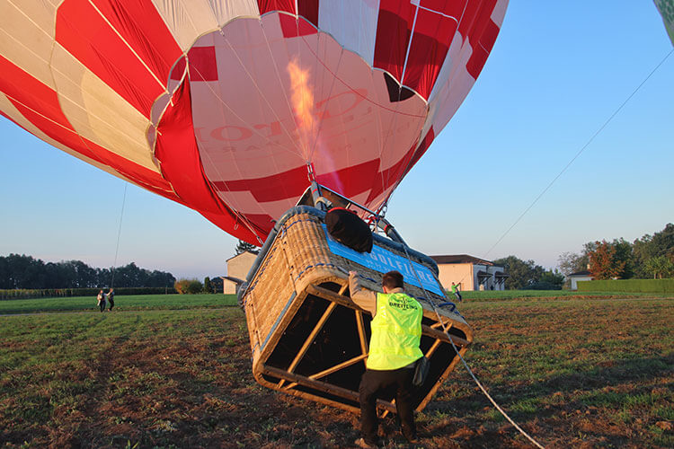 The pilot gets the hot air balloon ready on the ground by using bursts from the burners in Saint-Émilion