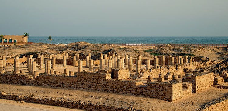A view over the columns of the ancient mosque in the Al Baleed Archaeological Park