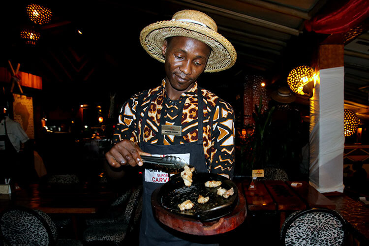 One of the servers bringing around crocodile meat at Carnivore