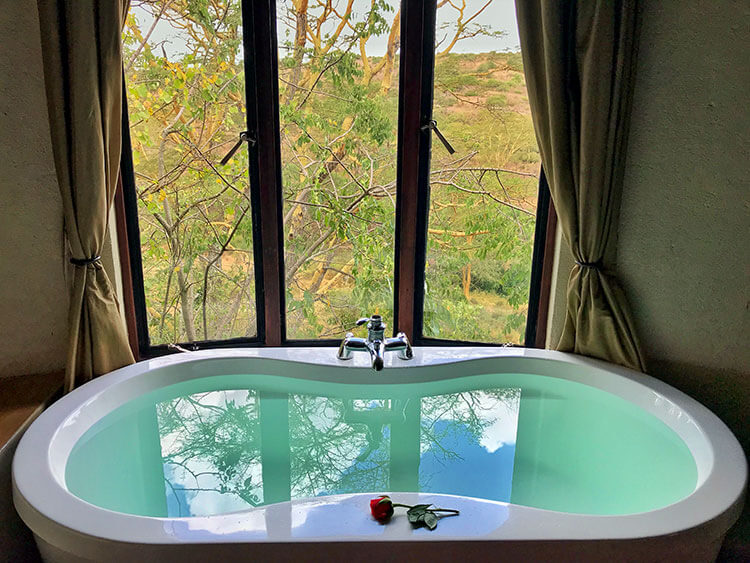 The bathtub with a forested view in our cottage at The Emakoko