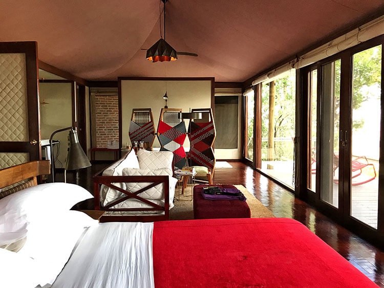 Our tent with queen size bed, sitting area, screen to separate the bathtub, and deck at Angama Mara