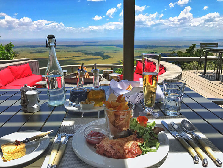 Chicken parmesan with salad and thick fries on the deck of the main lodge at Angama Mara