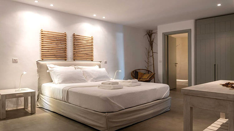 The bedroom at Villa Temptation in Mykonos with cream colors and minimalist design